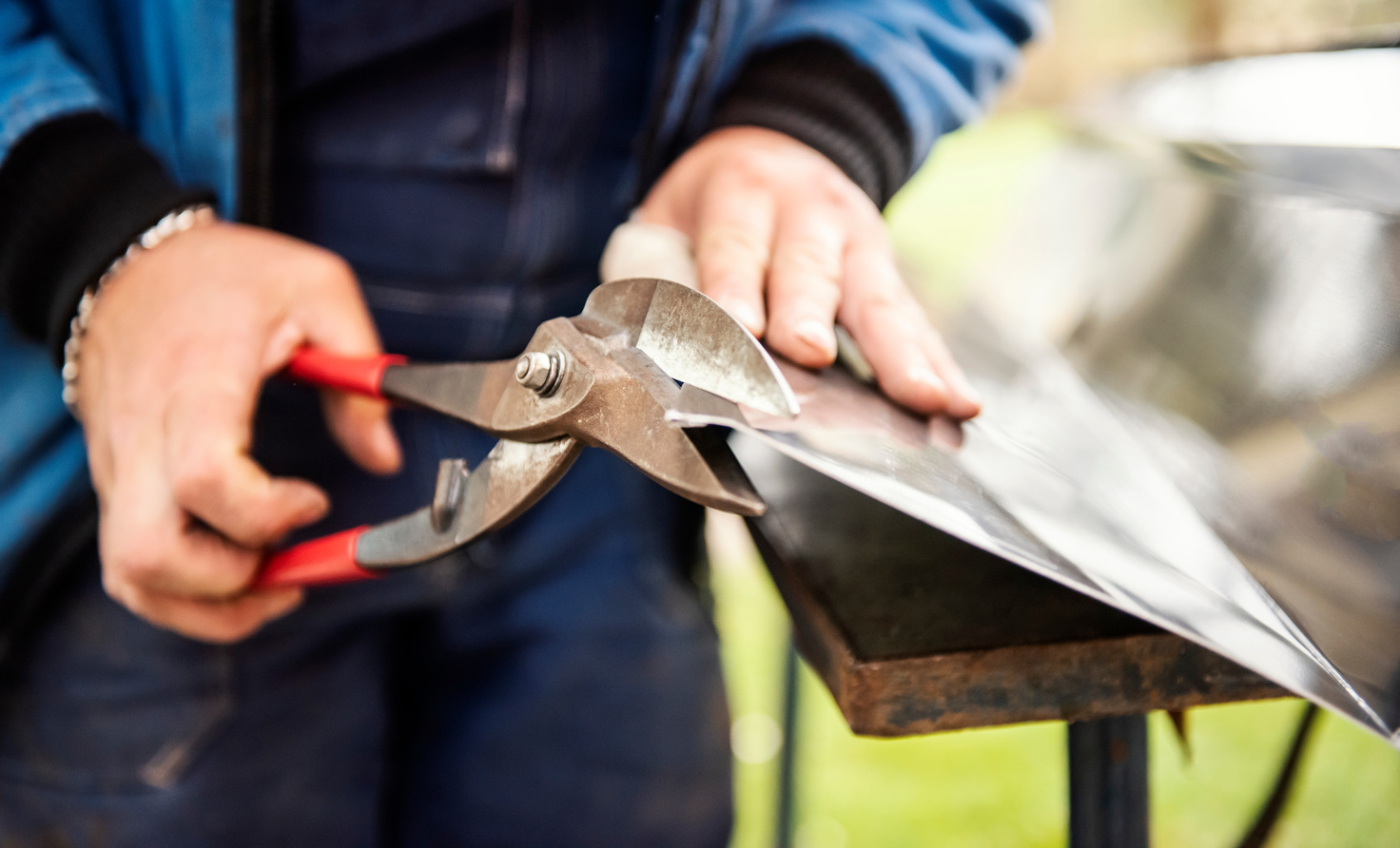 Metal worker cutting sheet metal